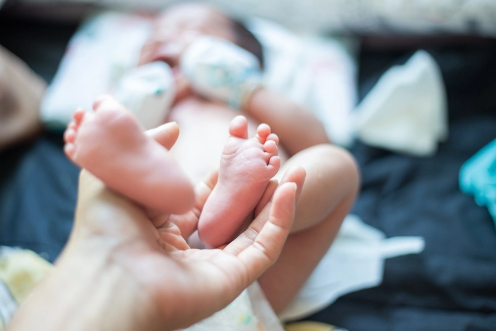 Baby feet holding by father hand massage selective focus, Baby healthy concept
