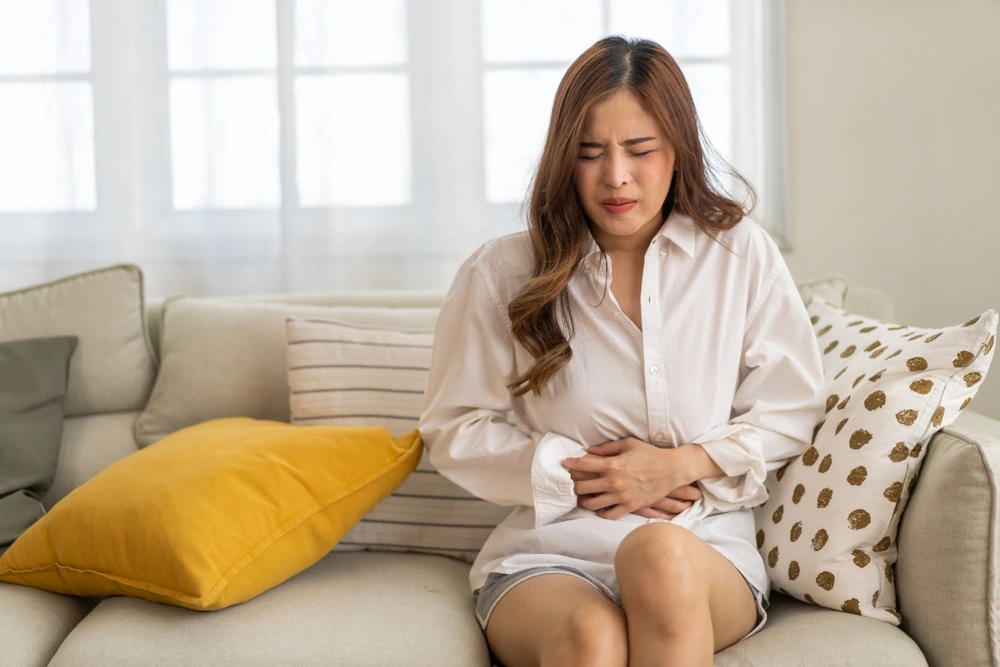 Young woman experiencing abdominal pain, uterus pain, reproductive system